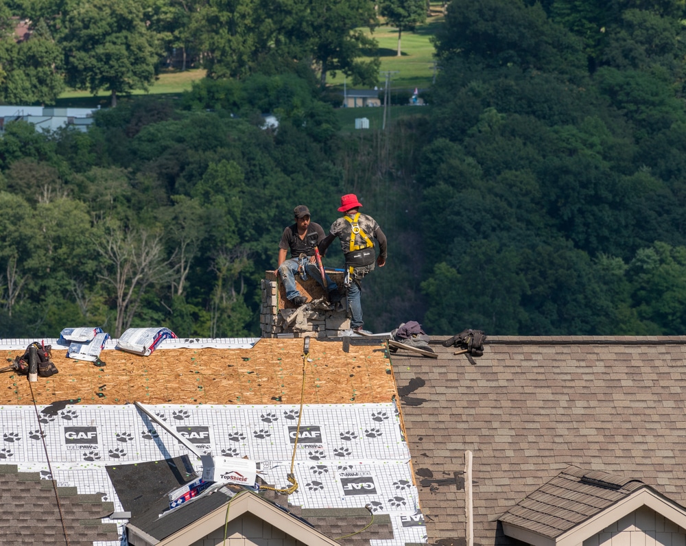 Crew preparing a roof for reroofing