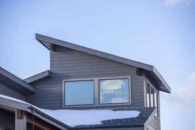 An exterior of a house under blue sky - roofing types