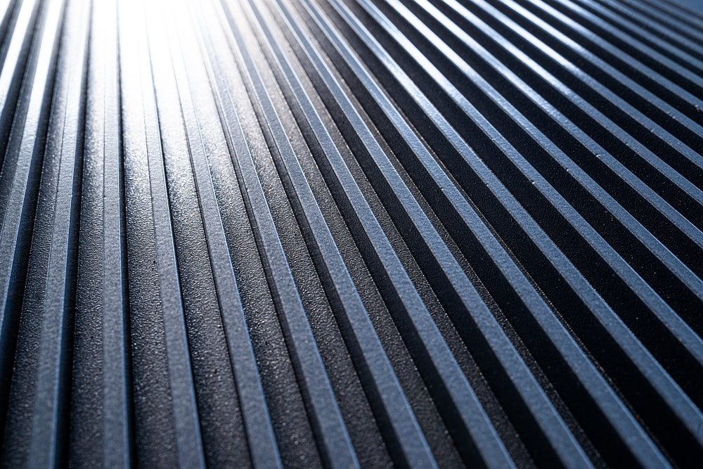 Close-up of a golden corrugated metal surface of unidentified equipment. the concept of sophisticated equipment and modern