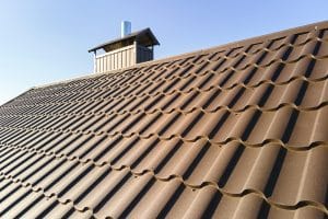 Closeup of house roof top covered with metallic shingles.