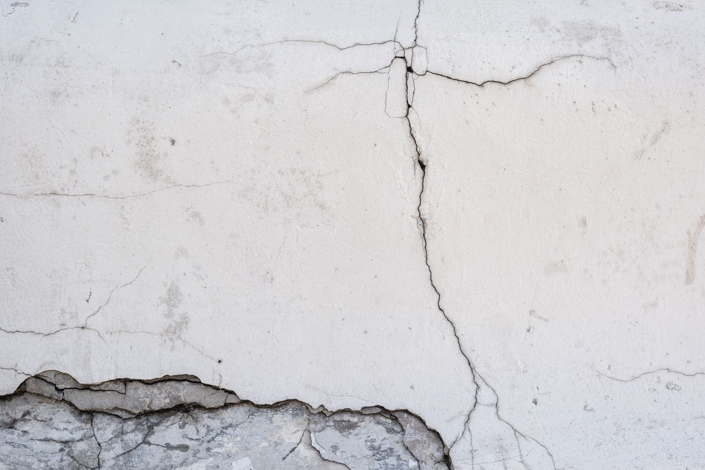 A crack running through a white plaster wall