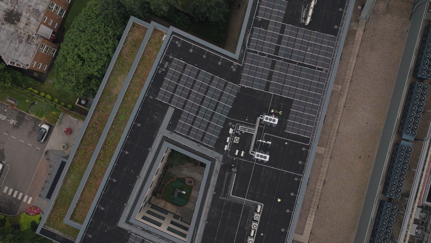 Aerial view of a dark flat roof on a large building
