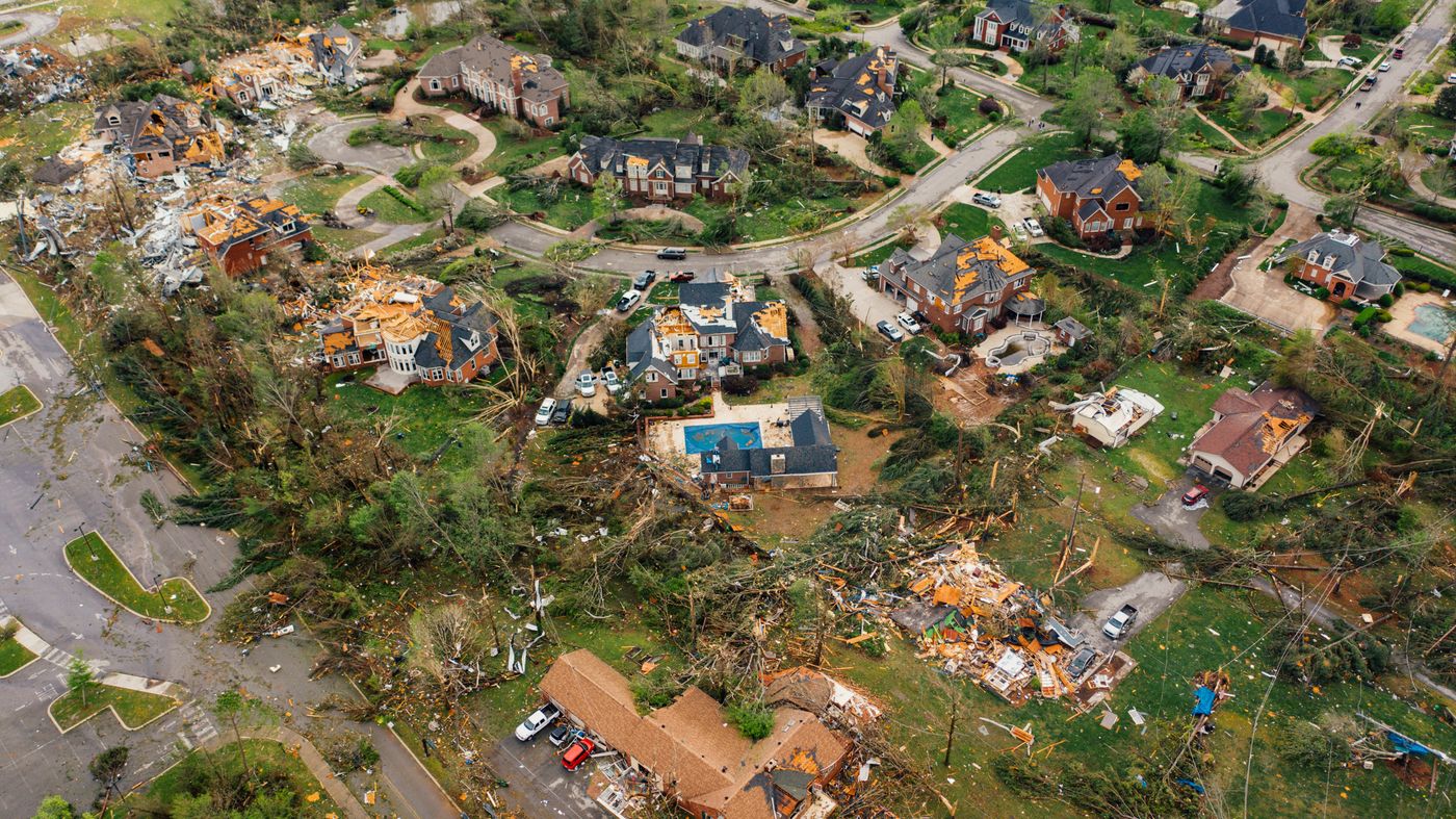 Aerial view of homes with roofs torn off after a storm