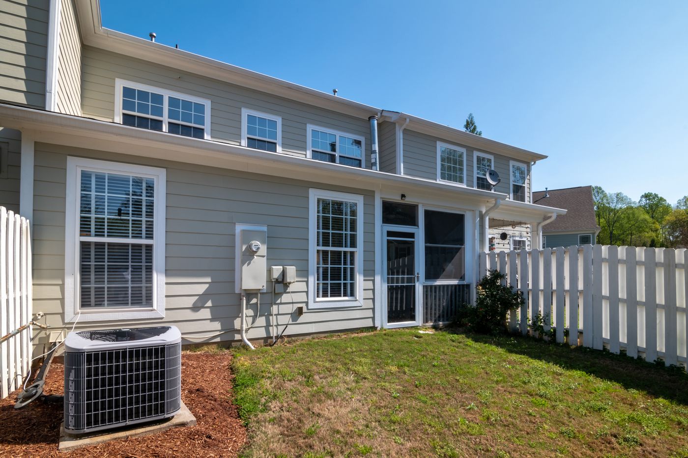 Air conditioning unit behind a house
