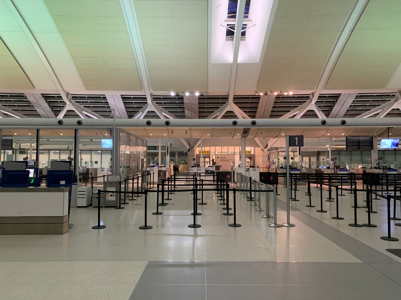 Airport check-in hall with empty queue lanes