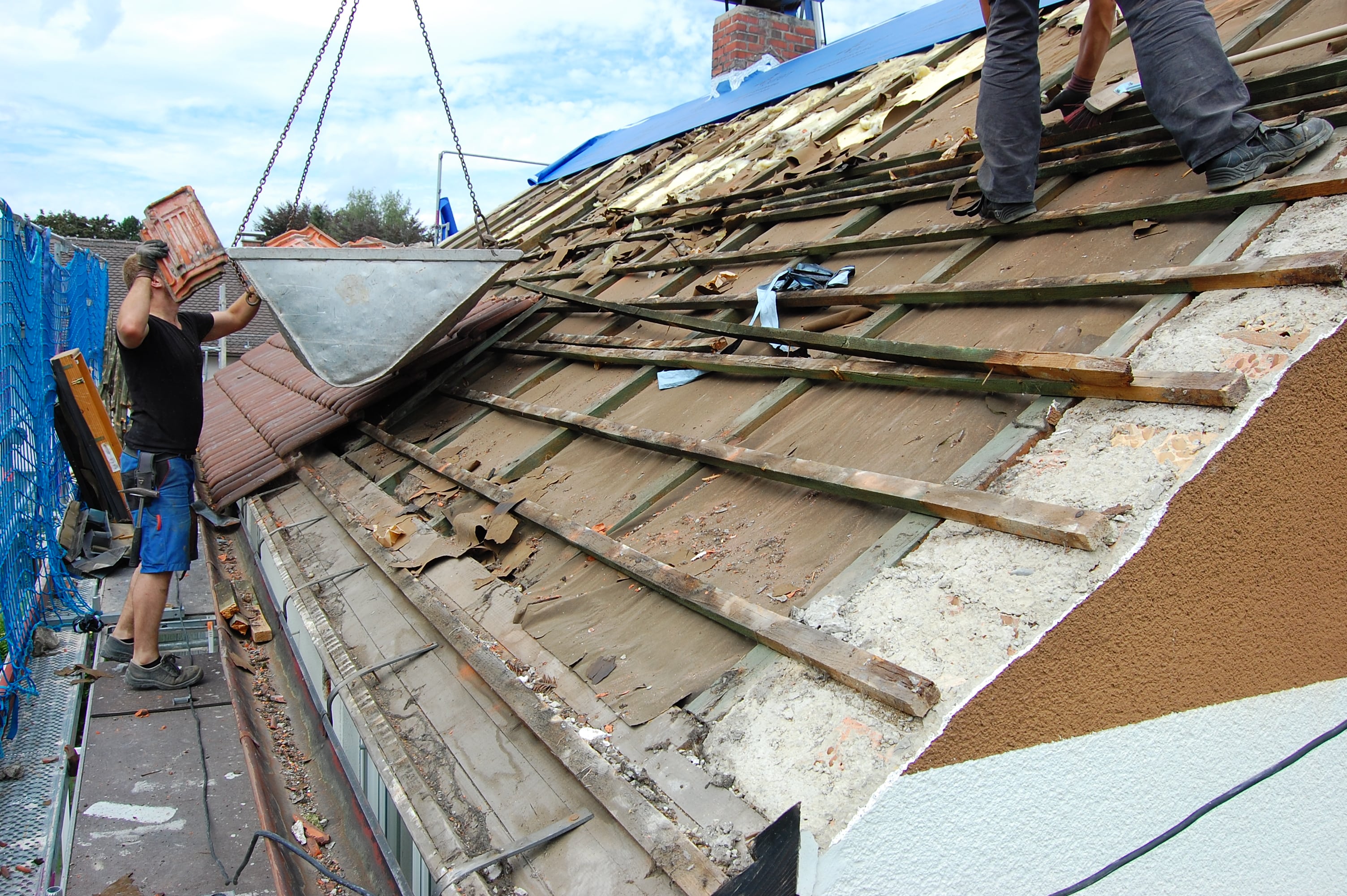 Old roofing being stripped from a house