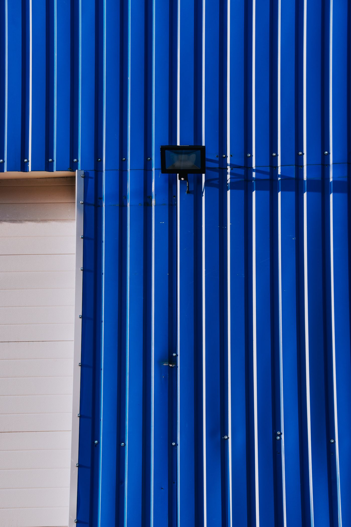 Blue industrial facade with metal siding
