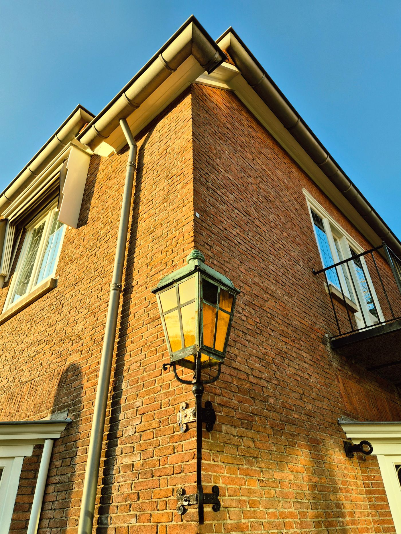 Brick house eaves with a gutter and downspout