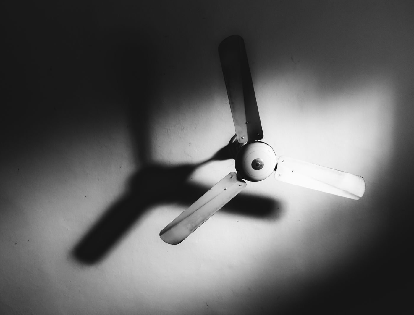 Ceiling fan casting shadows on a ceiling