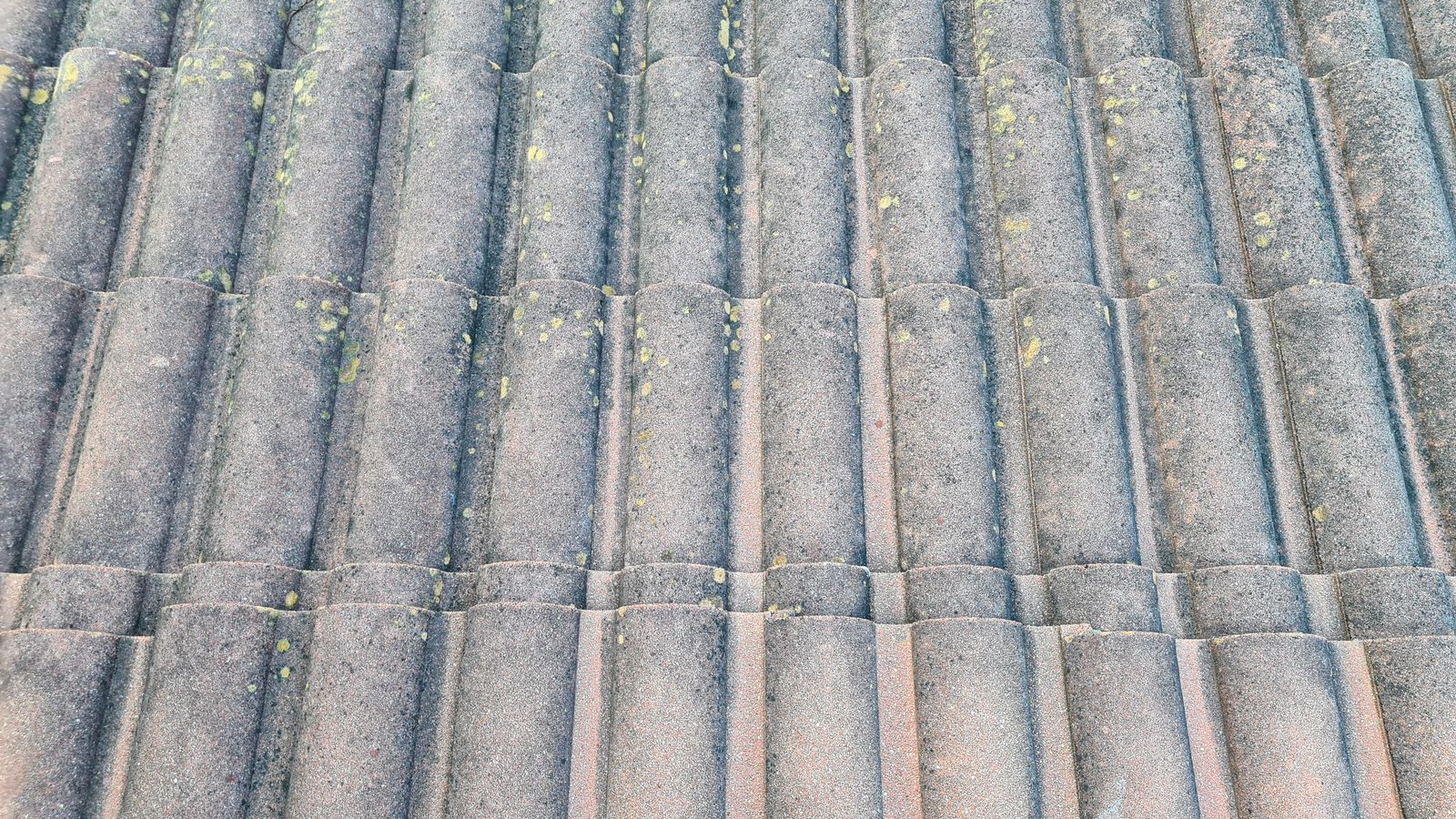 Close view of weathered concrete roof tiles