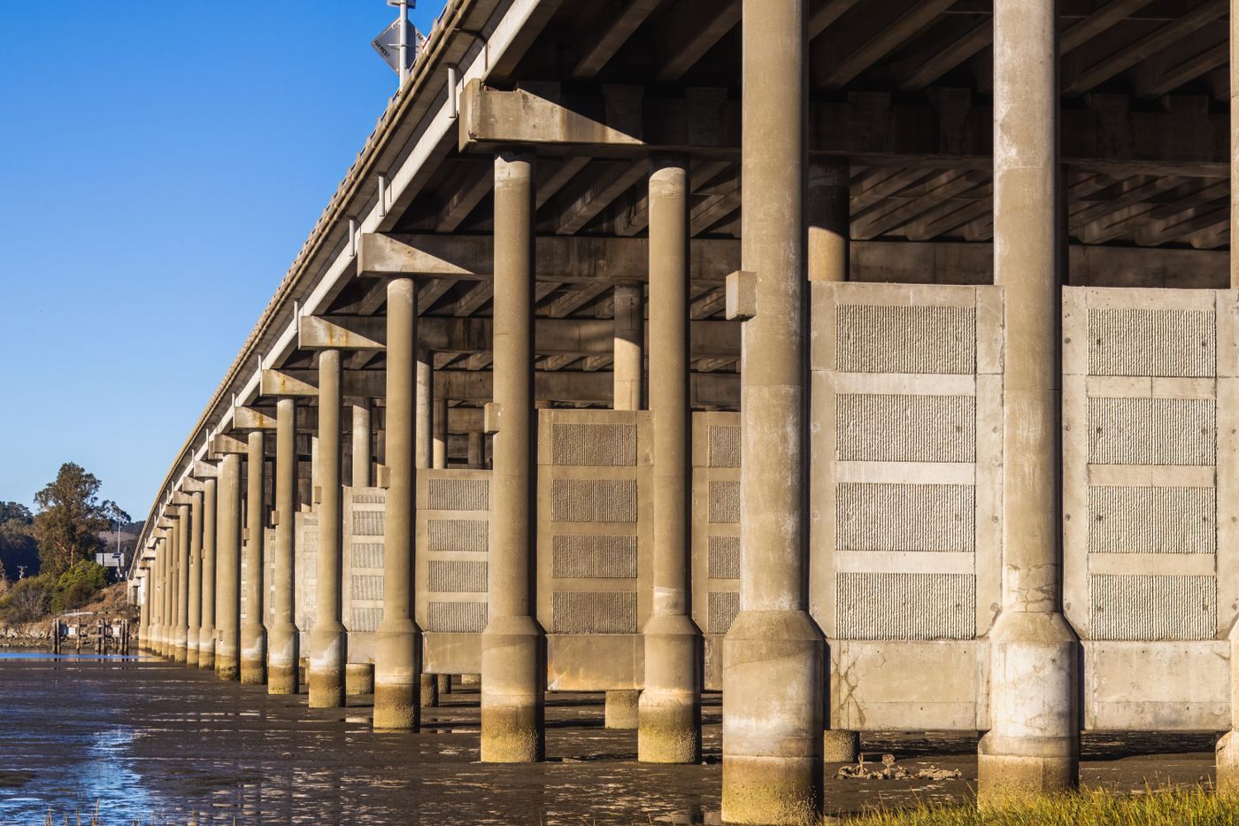 Concrete bridge piers standing in shallow water