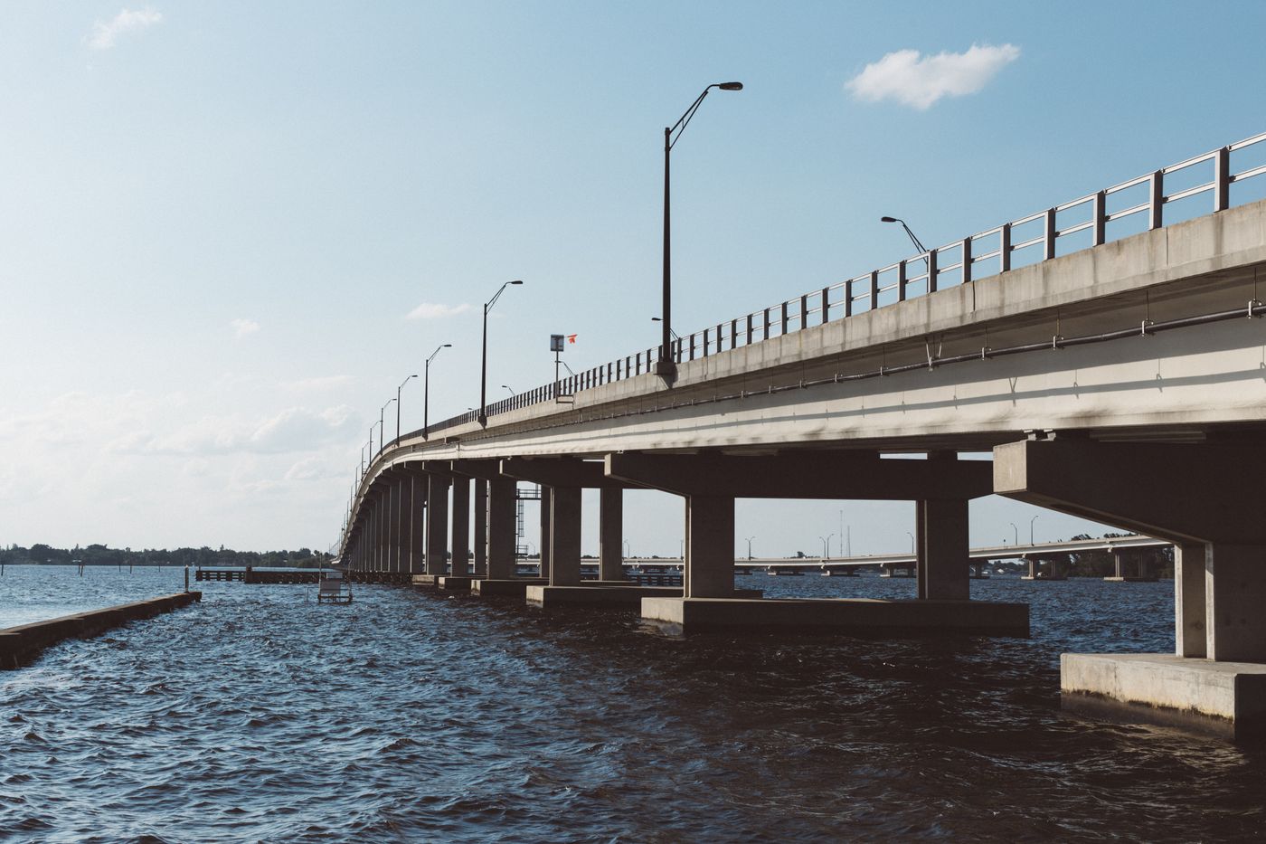 Concrete bridge with streetlights over open water