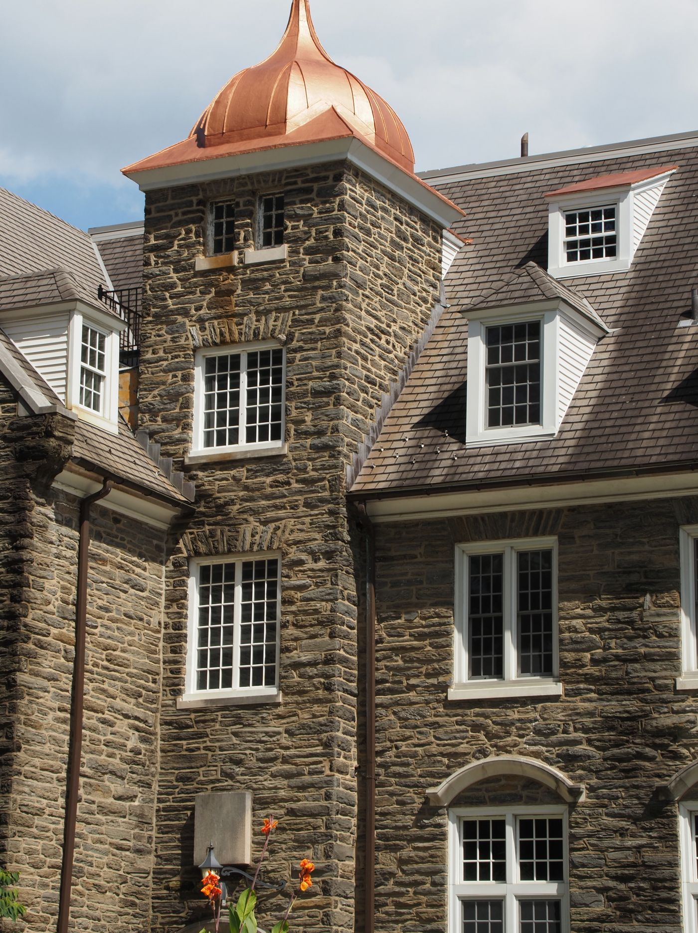 Copper dome on a stone building with dormers