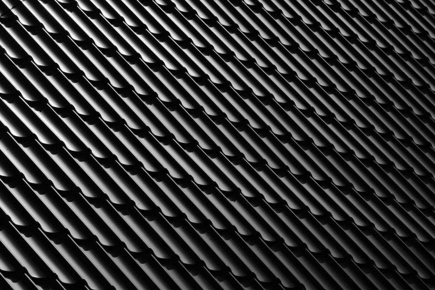 Dark metal roofing shaped like roof tiles