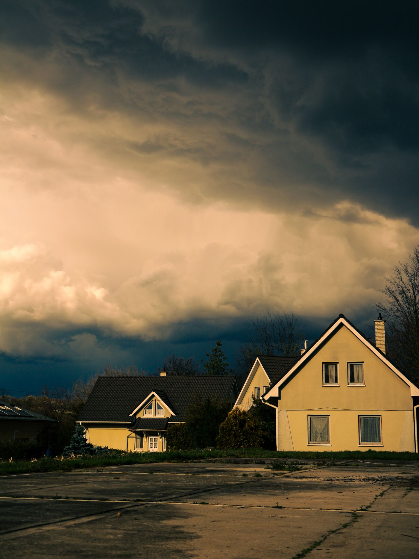 Dark storm clouds over two houses