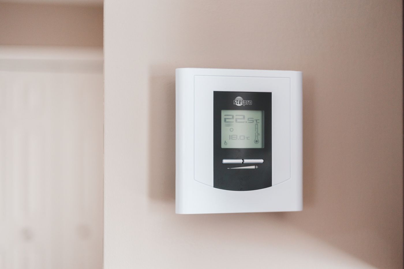 Digital thermostat on a wall