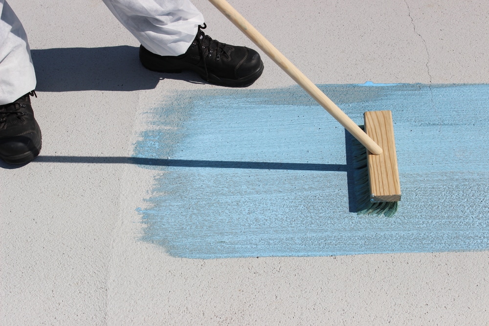 Blue coating brushed onto a flat roof