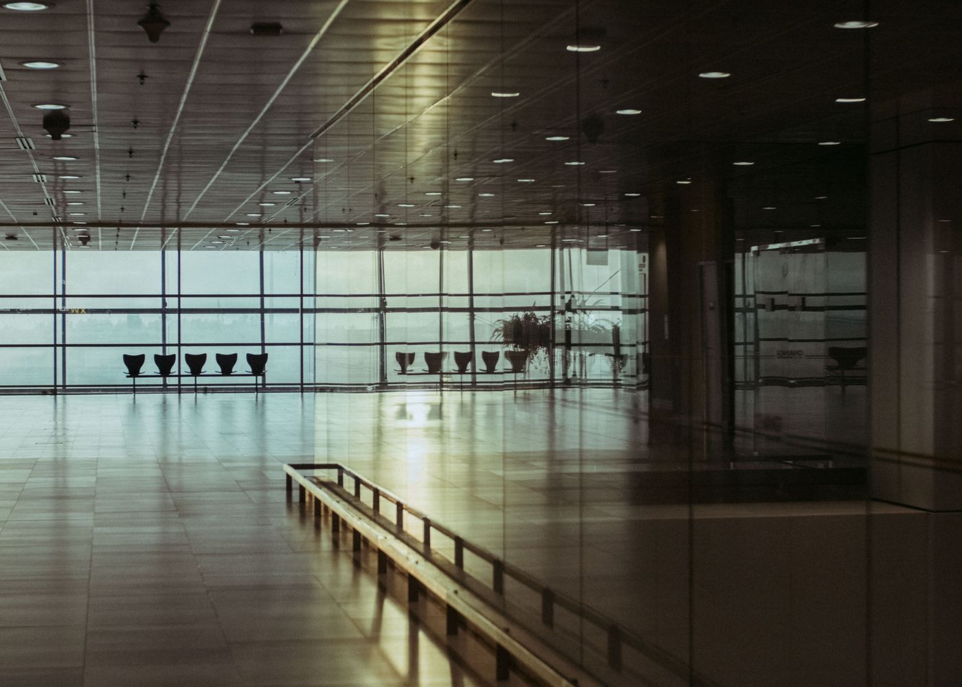 Empty airport terminal with tall windows