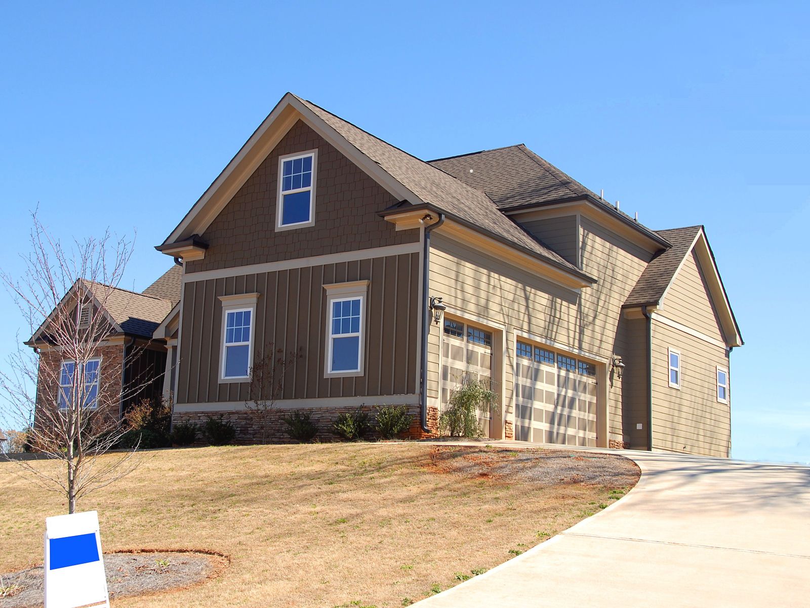 Suburban home with a finished asphalt shingle roof