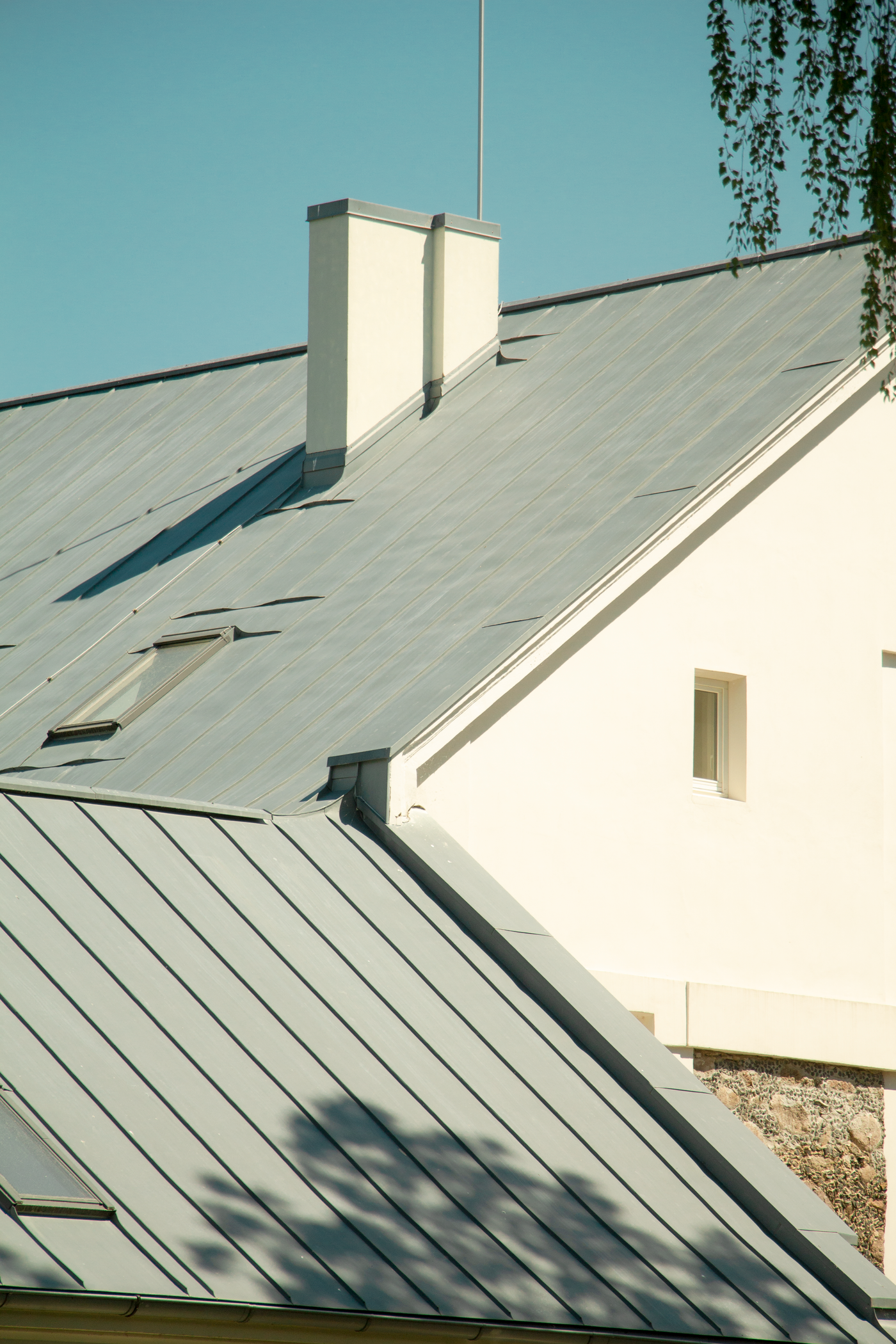 Gray metal roofs on a white house