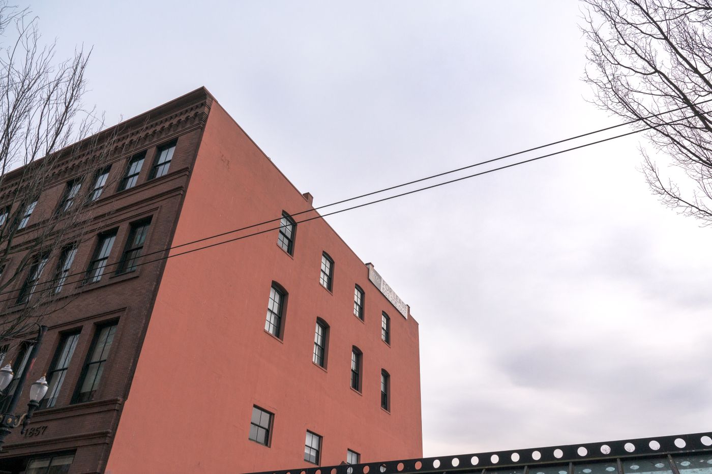 Historic brick building under a cloudy sky