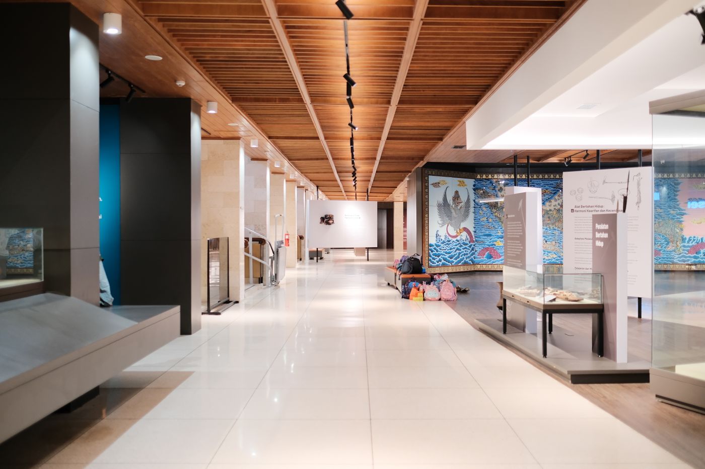 Long museum hall with display cases