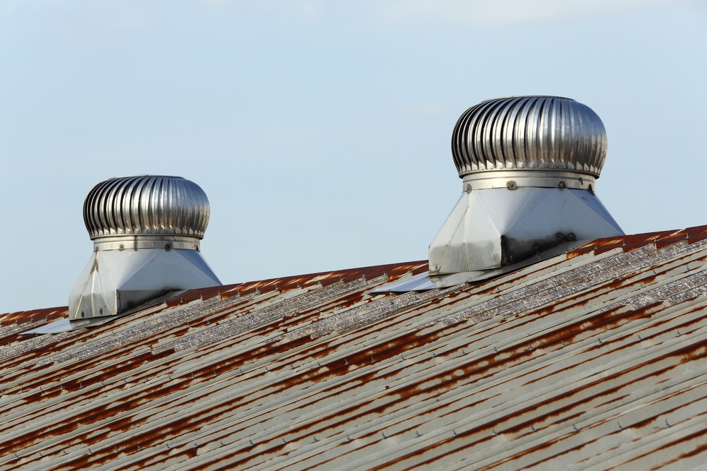 Weathered metal roof with turbine vents