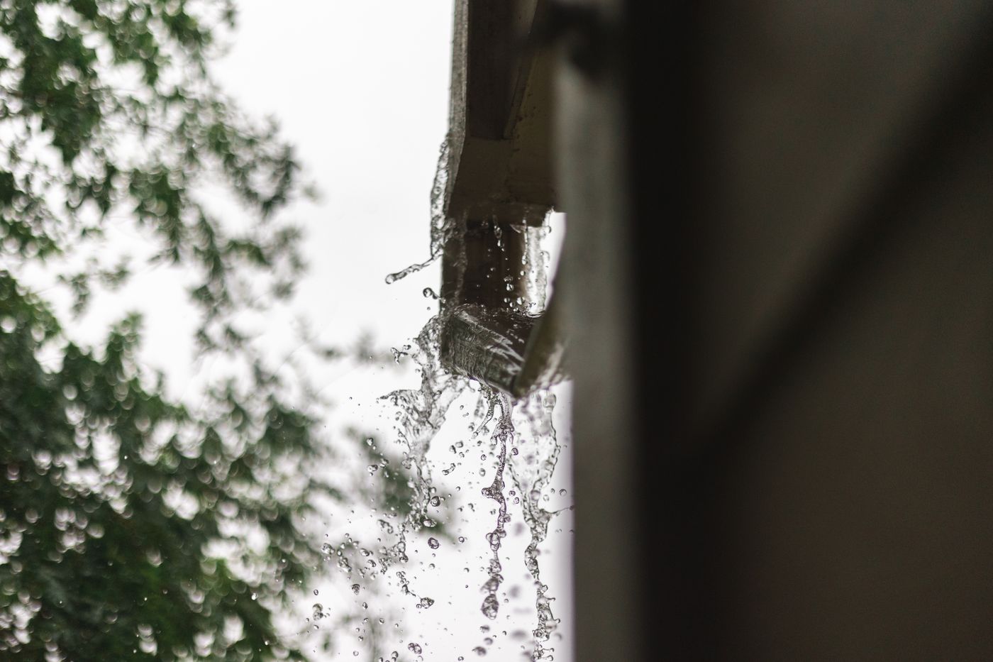 Rainwater pouring off a roof edge