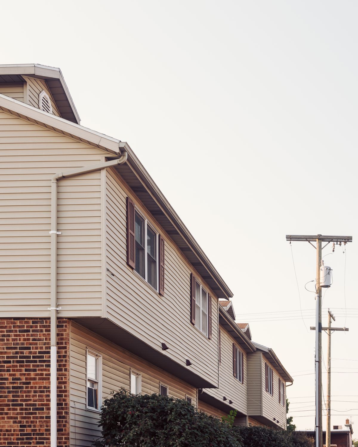 Exterior view of a two-story residential home with vinyl siding and asphalt shingle roofing