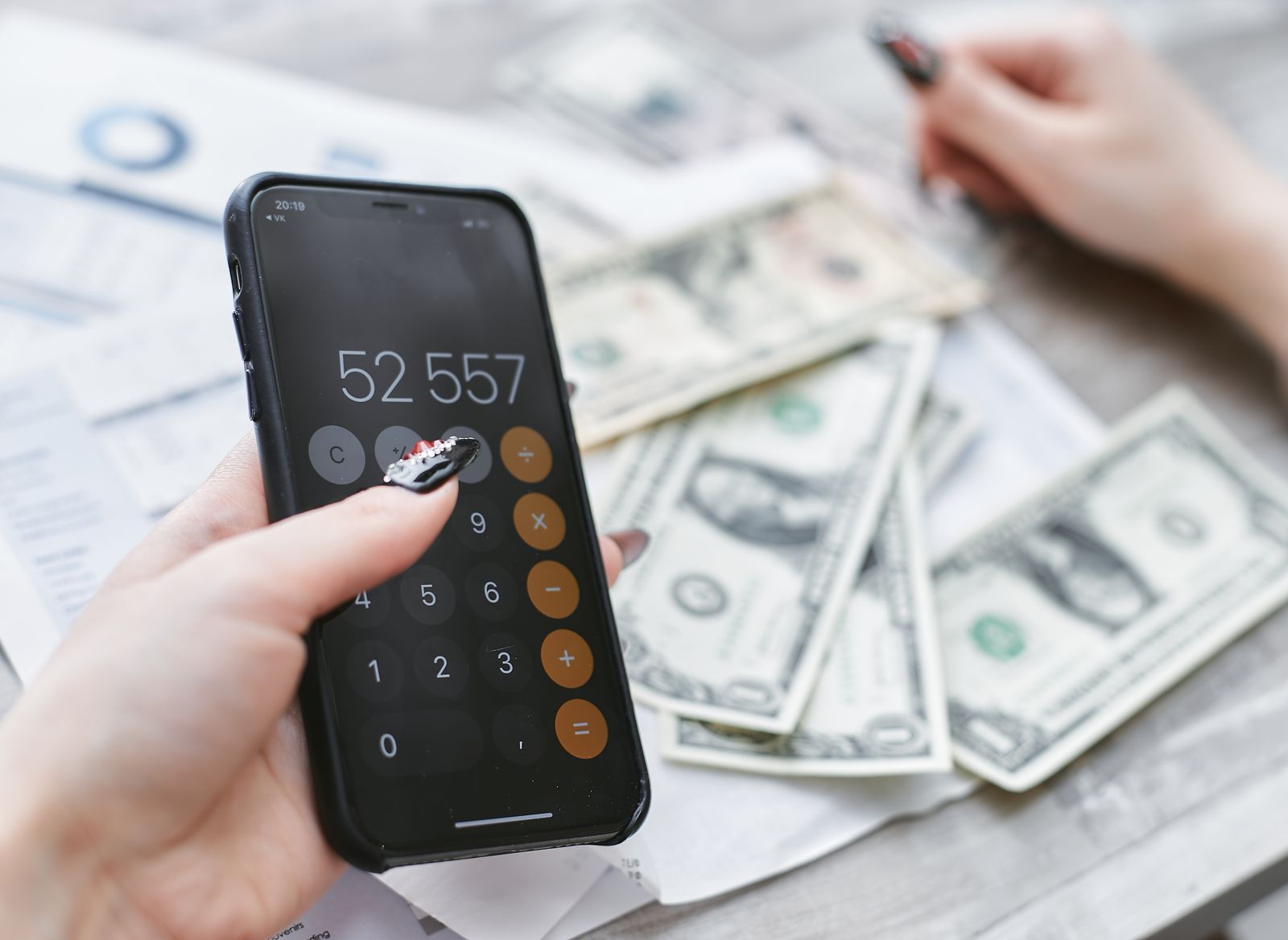 Calculating roof financing costs with a phone calculator and cash
