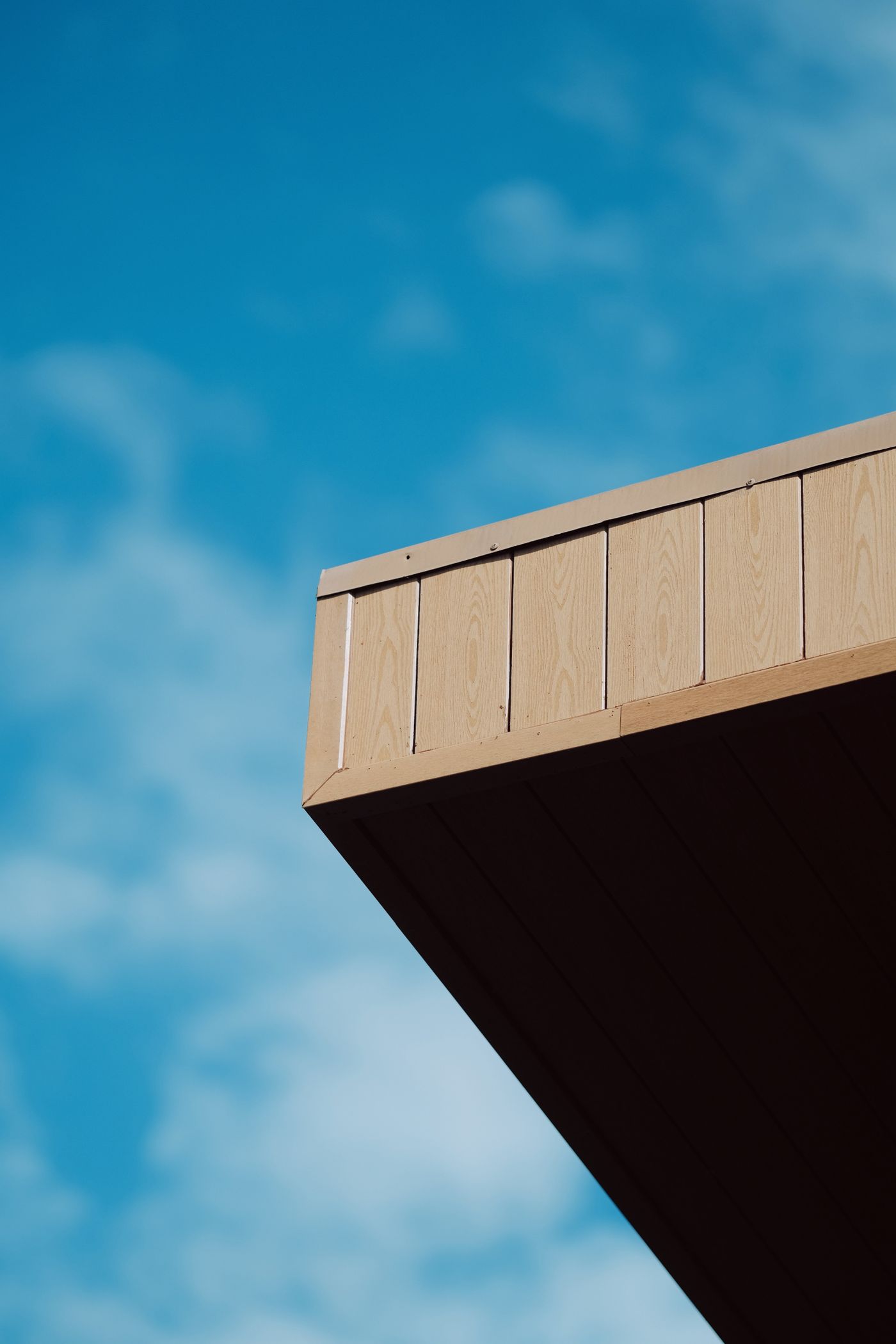 Roof overhang corner against a blue sky