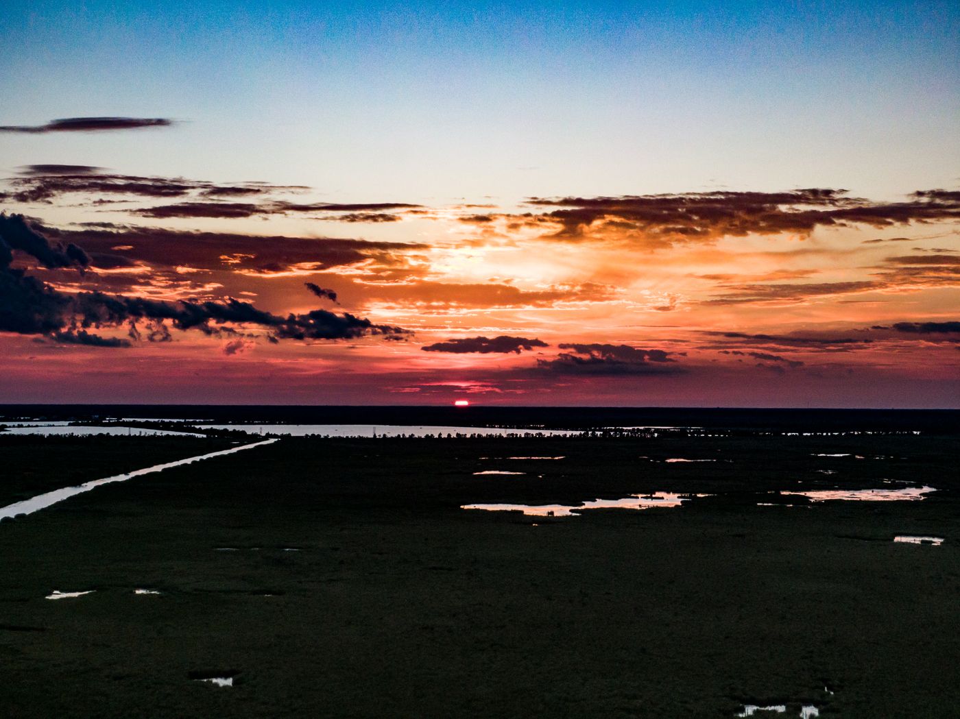Sunset over flat marshland