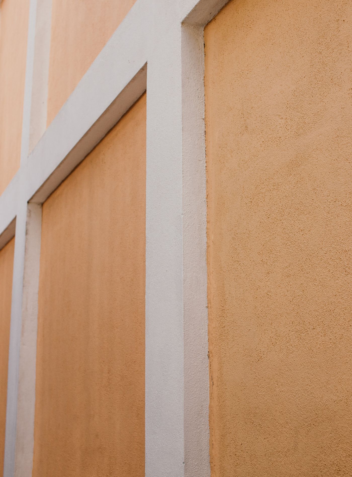 Textured stucco wall with concrete panels