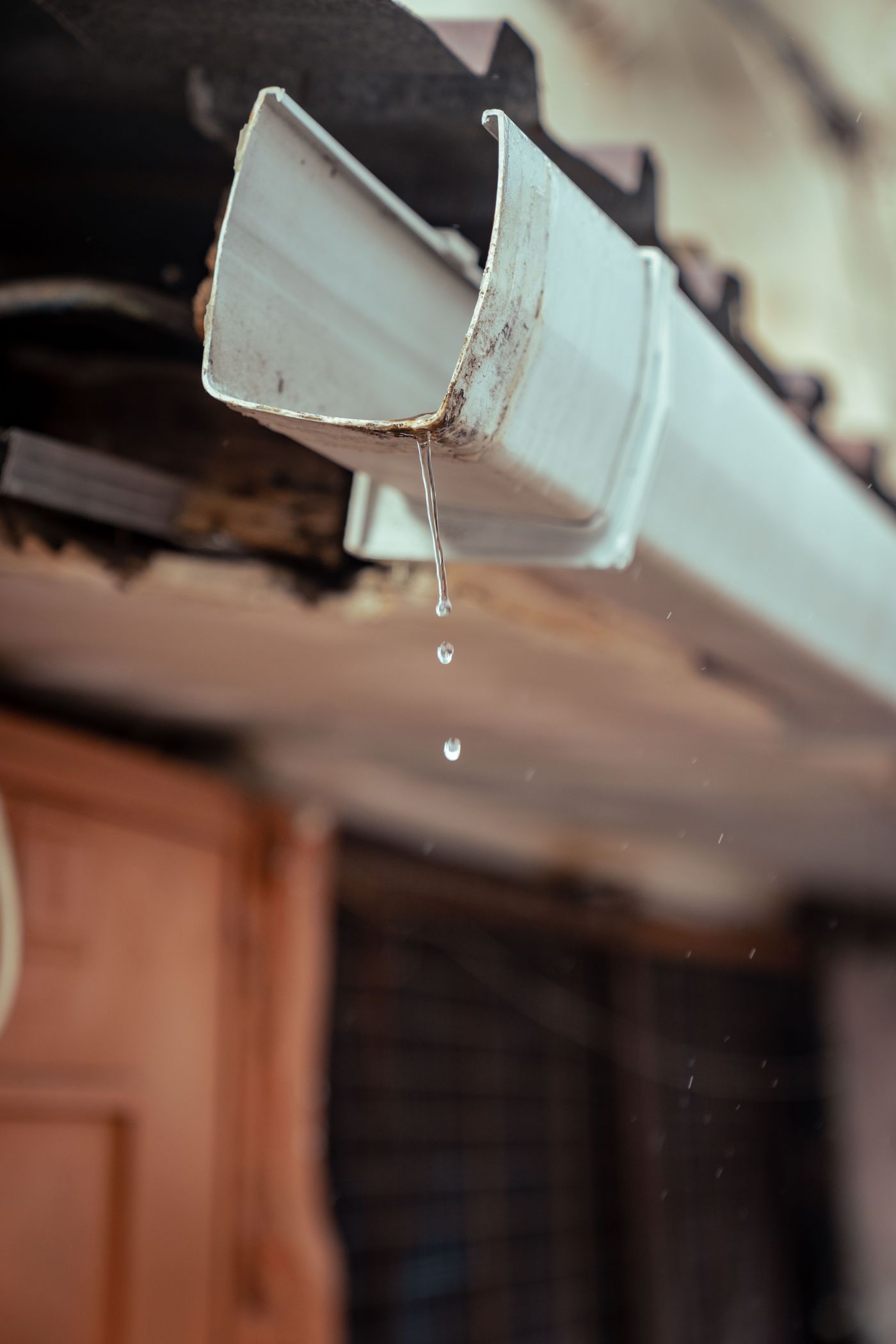 Water dripping from the end of a gutter