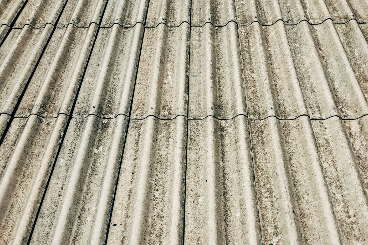 Weathered corrugated cement roof sheets