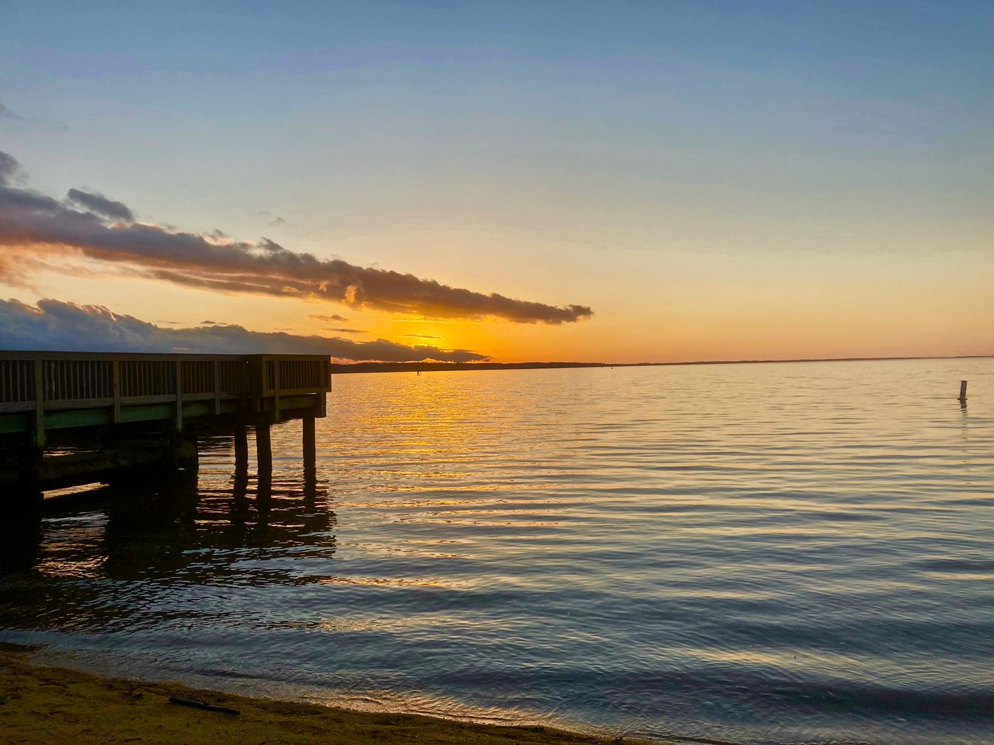 Wooden pier over a lake at sunset